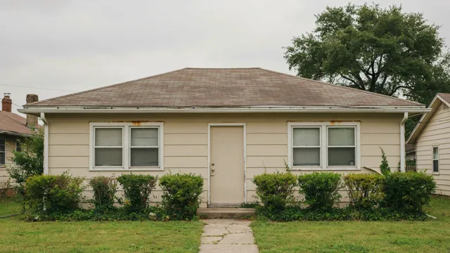 Weathered exterior siding and old windows, before renovation