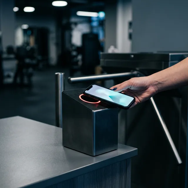 Phone tapping a check-in scanner representing the member portal module